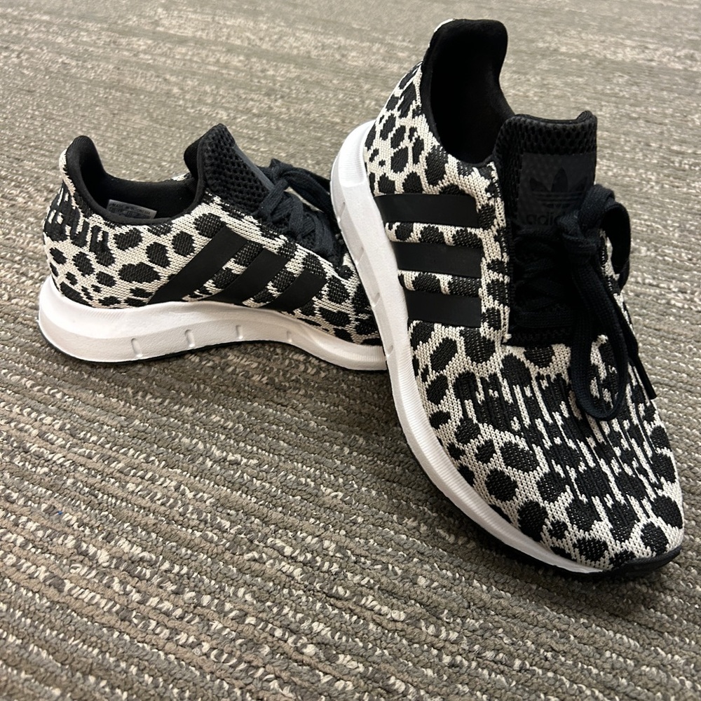 Women’s size 5.5 black cheetah print Adidas tennis shoes.